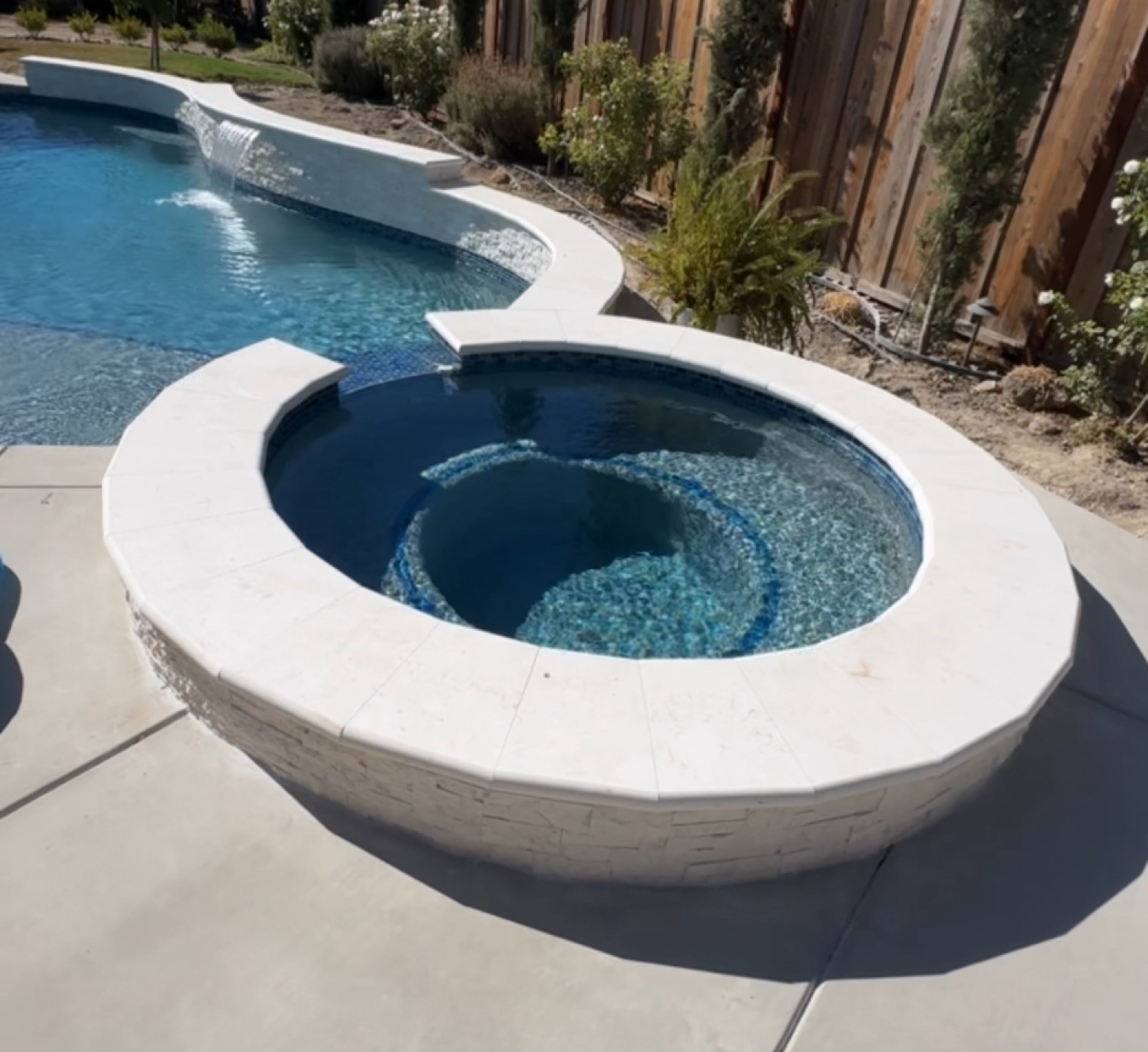 Circular spa with glass tilework