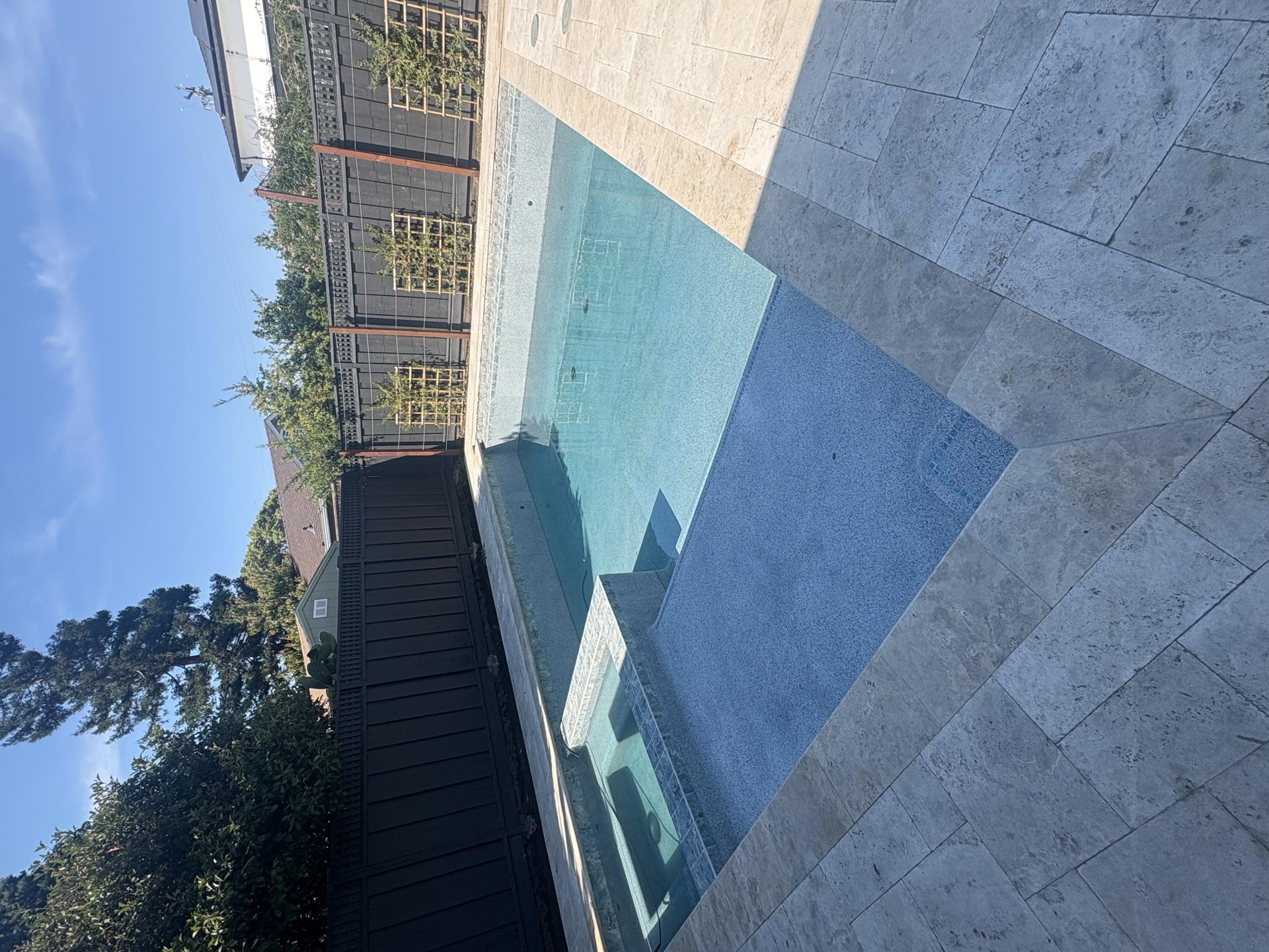 Rectangular pool with attached spa and travertine decking - project near Stockton, CA